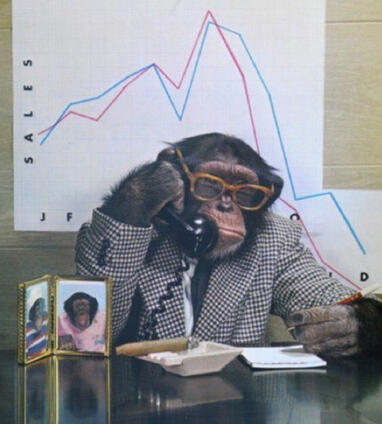 Monkey wearing a suit and a pair of glasses answering the phone.